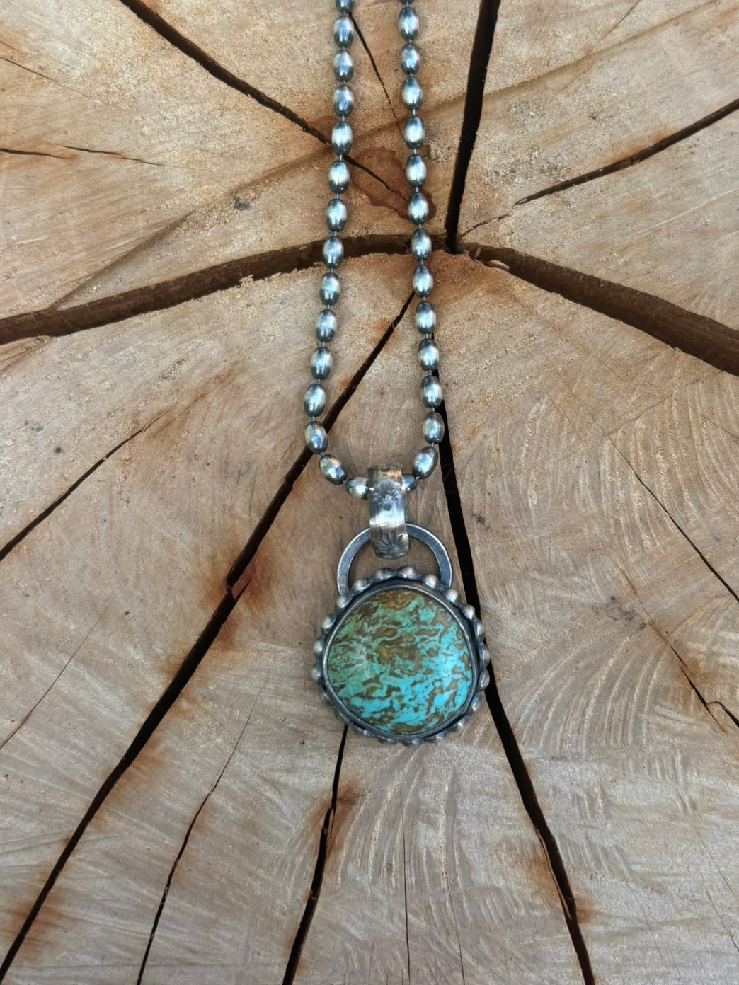 Necklace with a pendant on a wooden surface