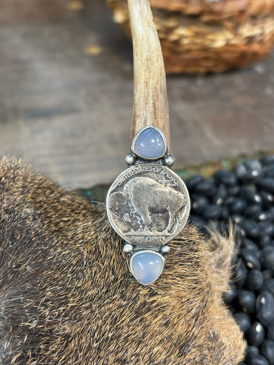 buffalo nickel ring with 2 opalite stones and silver shots. handmade and shown on a deer skull with baby antler