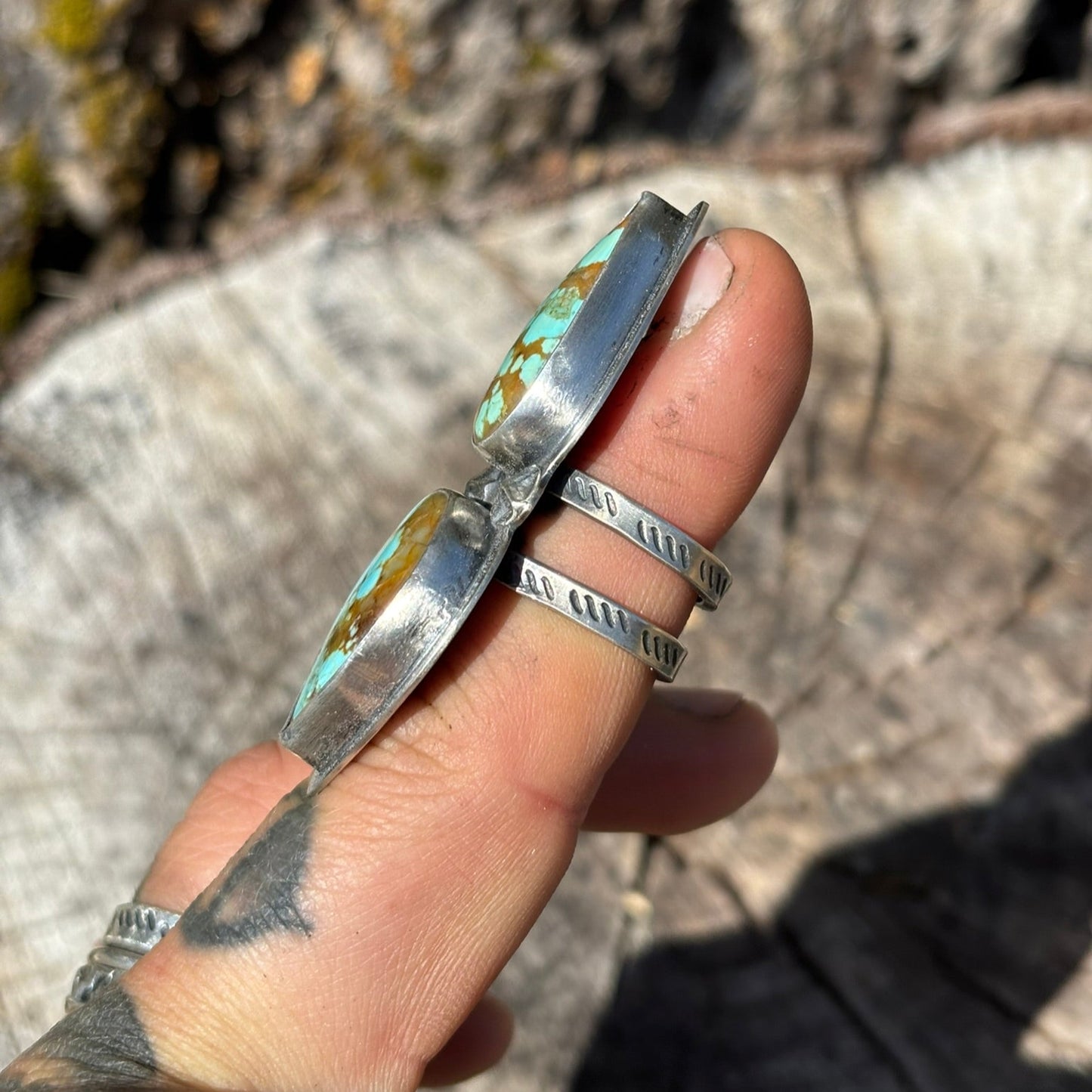 side view of turquoise and silver handmade ring showing the hand stamped double band