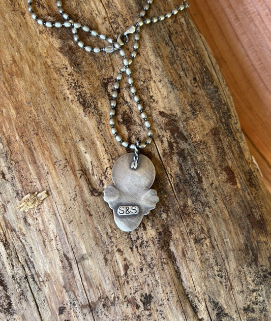 back view of a handmade buffalo nickel and variscite pendant with hand stamped artist signiture
