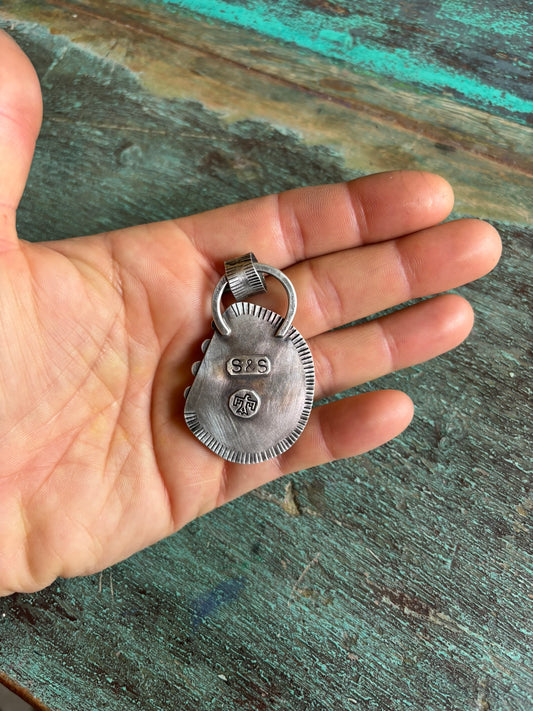 back side of large sterling and fine silver handmade pendant showing artist stamp and thunderbird patch detail