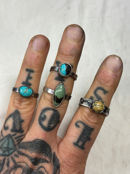 4 simple rings of various colors turquoise and variscite some on simple bands and one on handstamped detailed band with dark patina to show details