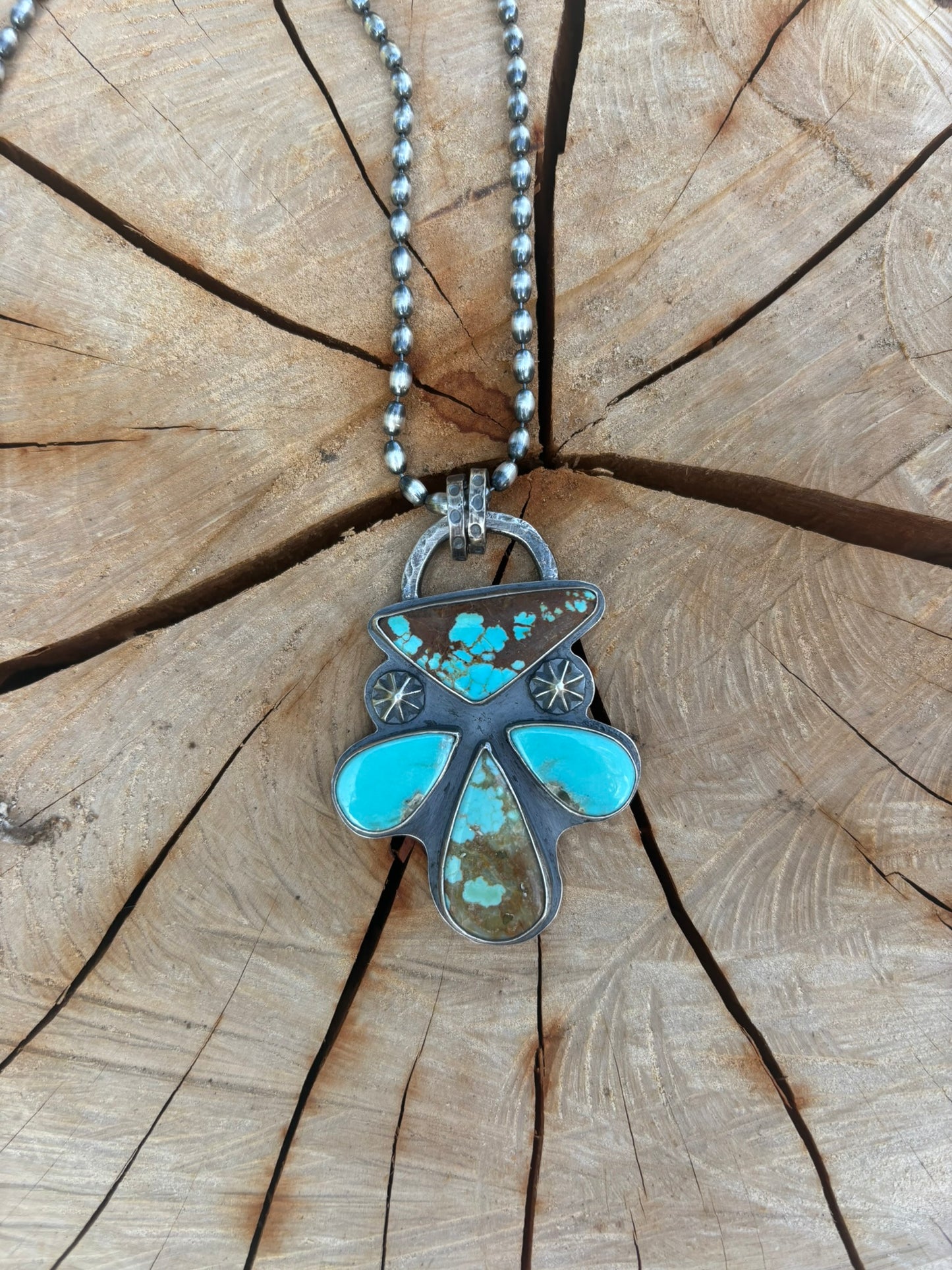 Turquoise pendant necklace on a wooden surface
