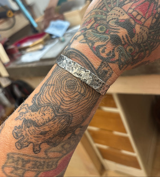 Reserved- Hammered thunderbird cuff.