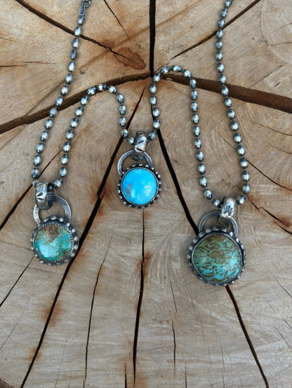Necklace with turquoise stones on a wooden surface