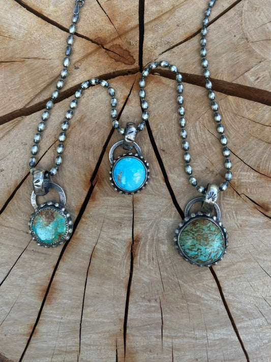 Necklace with turquoise stones on a wooden surface