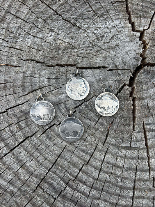 4 buffalo head nickel pendants shown on cracked wood round