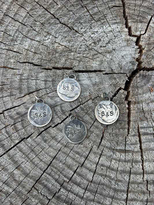 back side of buffalo nickel pendants showing stamped signature
