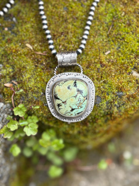 handmade double bezel variscite pendant on navajo pearl strand on mossy rock. double bail stamped details and backplate stamping by hand. twist wire and stamped detail bail can accommodate 6-8mm chain