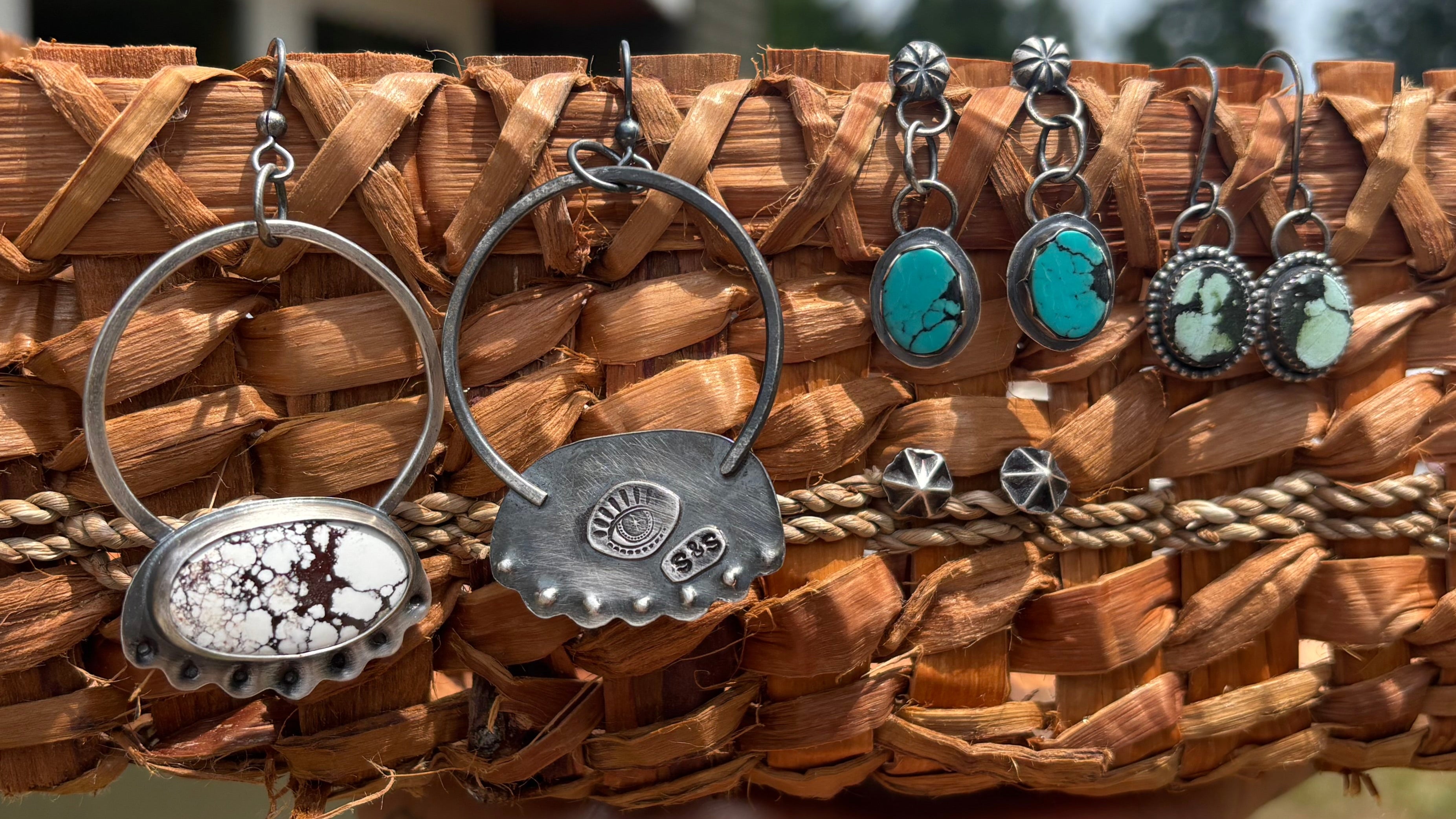 handmade earring sets (silver and turquoise) shown on a handmade cedar basket background