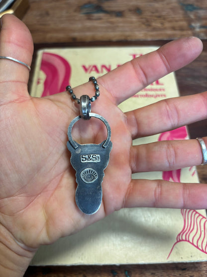 Hand holding a silver bottle opener keychain with 'S&S' branding.