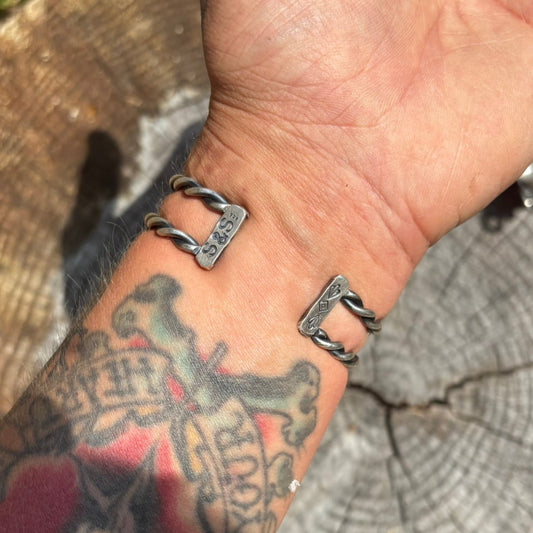 back side of a handmade silver and turquoise cuff