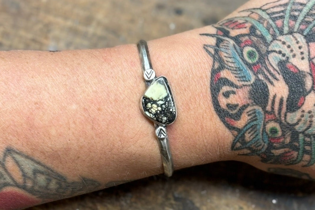 variscite cuff bracelet with hand stamped silver embellishments on hammered triangle wire band. 