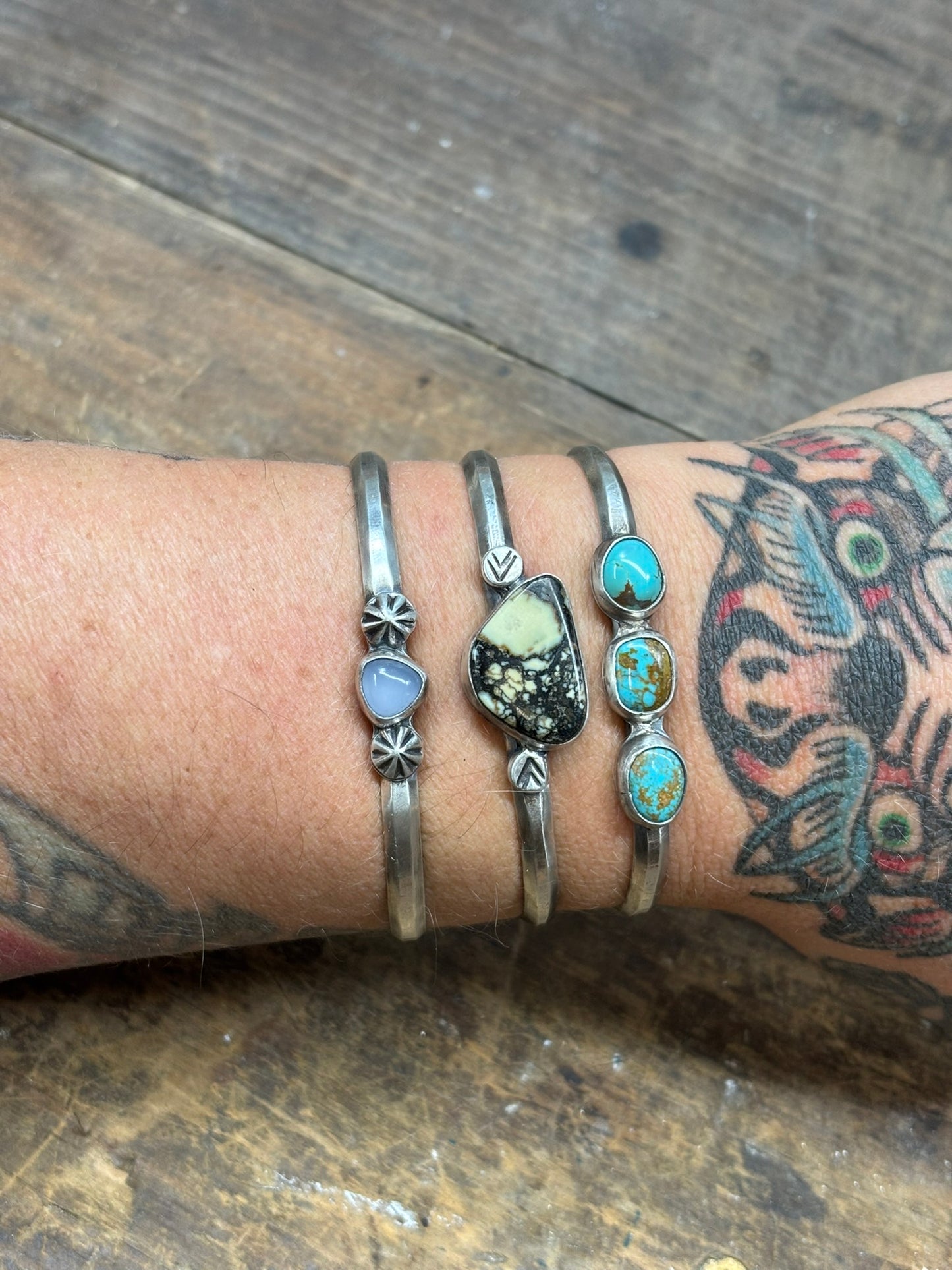 3 cuff bracelets with opalite, variscite and turquoise stones on hammered triangle band with silver embellishments. hand stamped 925 and artist signed inside band