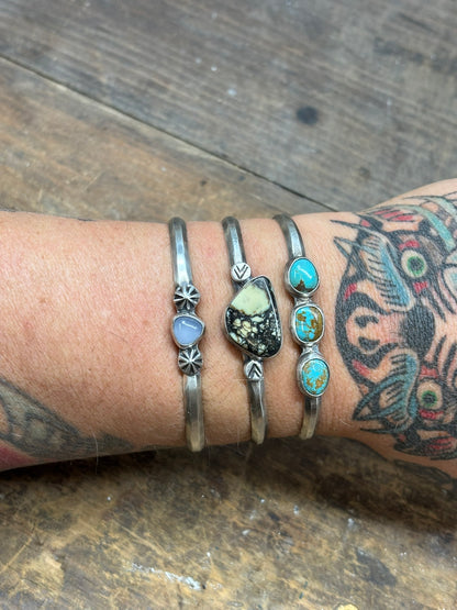 3 cuff bracelets with opalite, variscite and turquoise stones on hammered triangle band with silver embellishments. hand stamped 925 and artist signed inside band